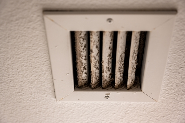 White HVAC vent showing dirt and mould growth from daily use