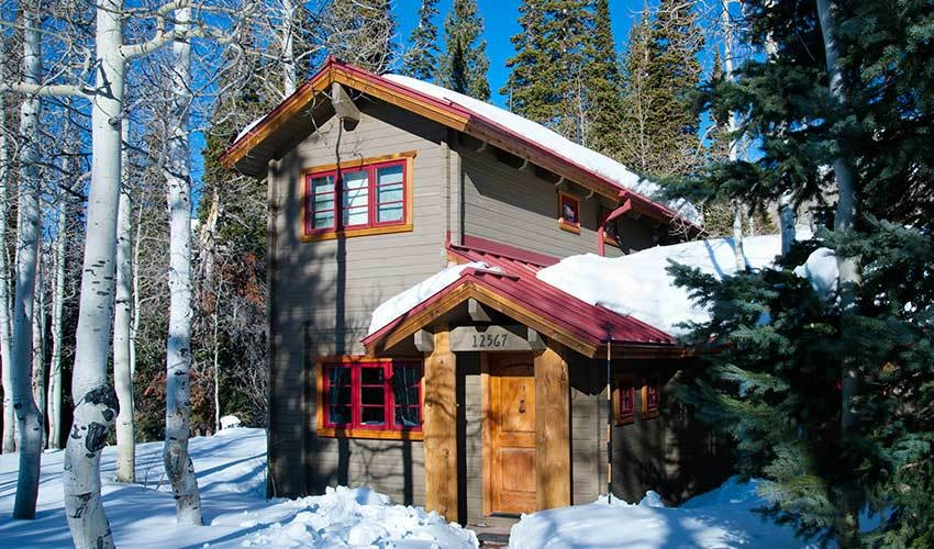 Winter cabin covered with snow