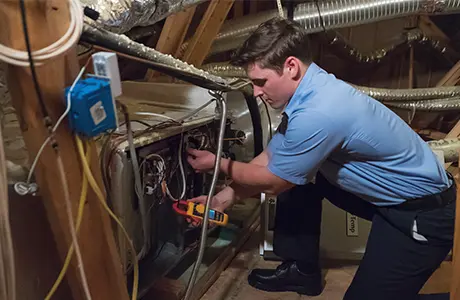 Technician repairing heating unit.